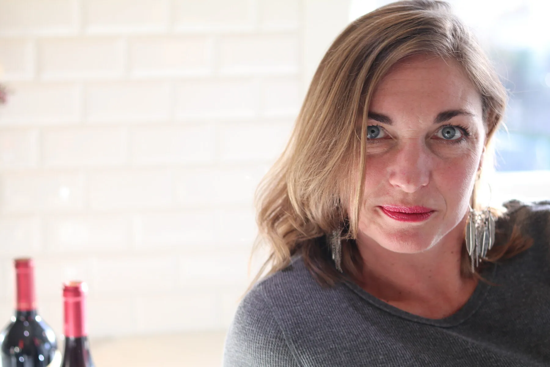 Georgia, a close-up portrait against a white brick wall