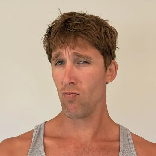 Kylen in a gray tank top pulling a face for the camera, photo booth shot 2 of 12