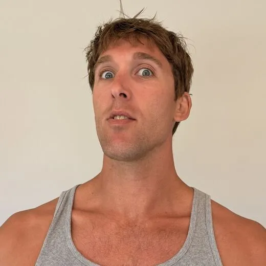 Kylen in a gray tank top pulling a face for the camera, photo booth shot 4 of 12