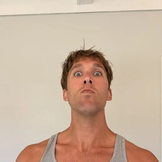 Kylen in a gray tank top pulling a face for the camera, photo booth shot 5 of 12