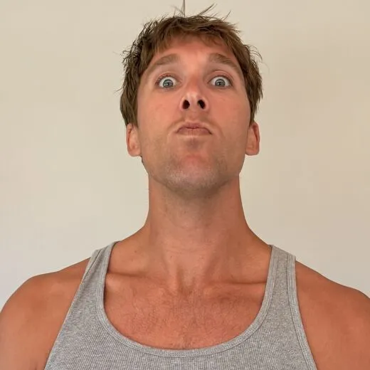 Kylen in a gray tank top pulling a face for the camera, photo booth shot 6 of 12