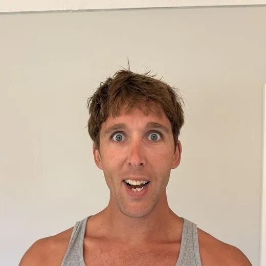 Kylen in a gray tank top pulling a face for the camera, photo booth shot 7 of 12