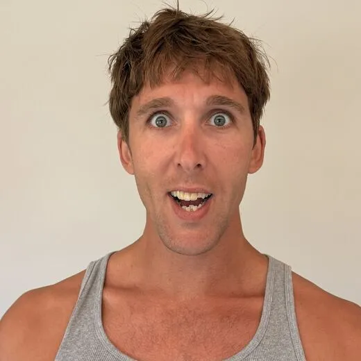Kylen in a gray tank top pulling a face for the camera, photo booth shot 8 of 12