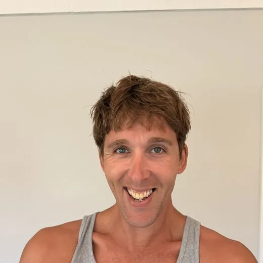 Kylen in a gray tank top pulling a face for the camera, photo booth shot 9 of 12