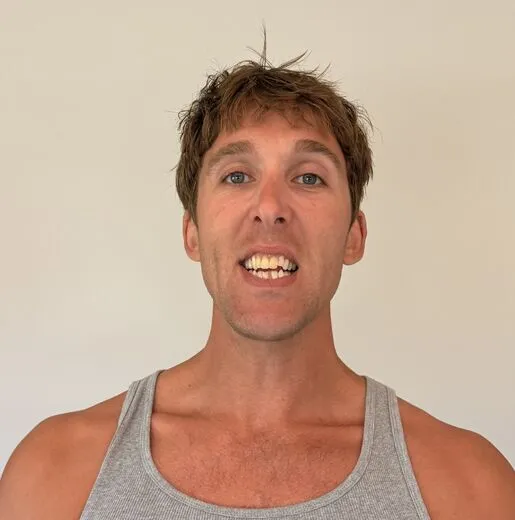 Kylen in a gray tank top pulling a face for the camera, photo booth shot 11 of 12