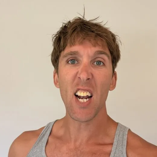 Kylen in a gray tank top pulling a face for the camera, photo booth shot 12 of 12