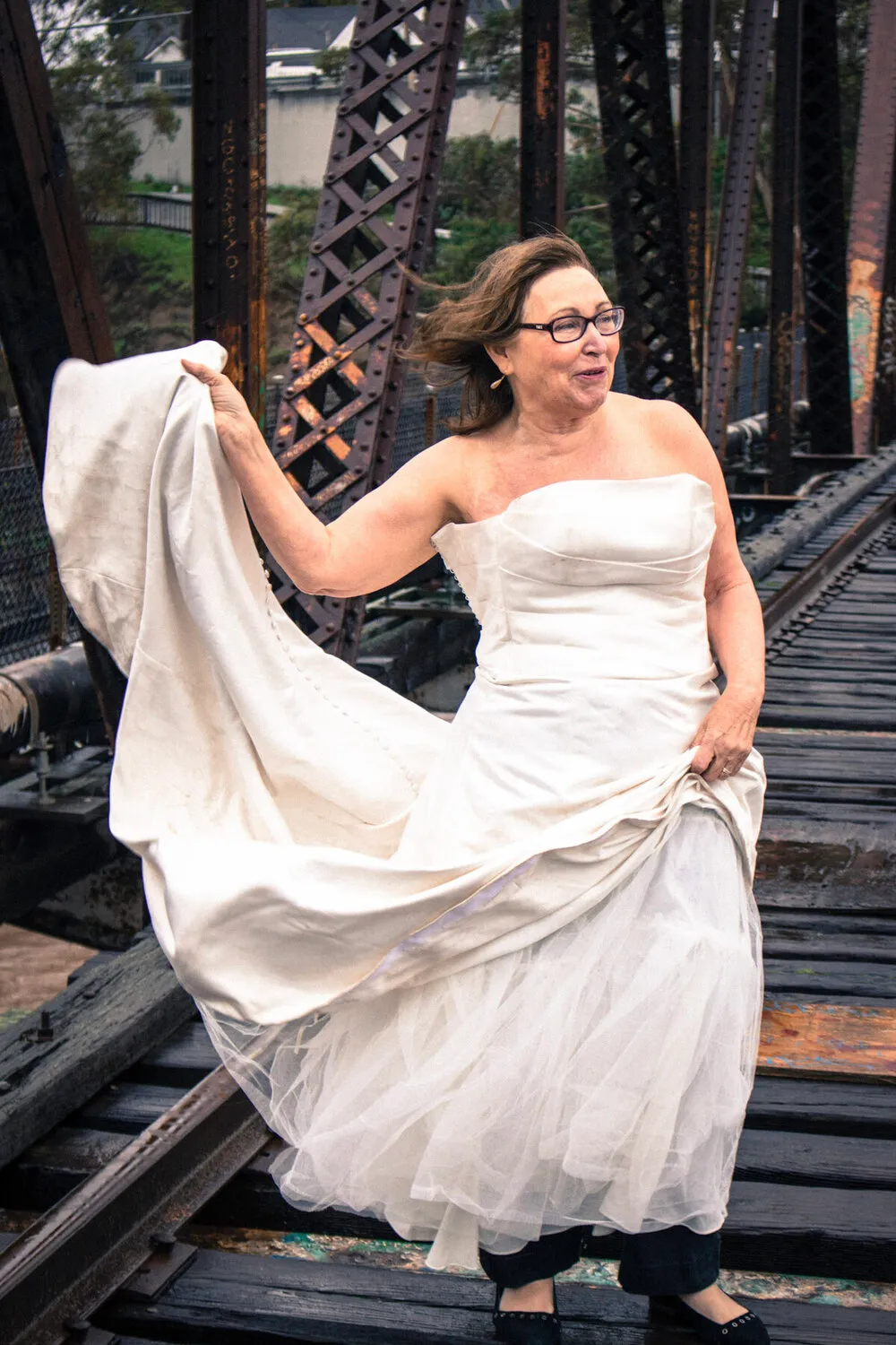 Kenda's mom in The Divorce Dress, swirling the skirt on an old railroad bridge